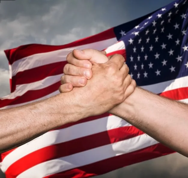A handshake between two individuals, one with a US flag pin and the other with a Mexican flag pin, symbolizing diplomatic efforts and cooperation in trade discussions, against a backdrop of blurry agricultural fields.