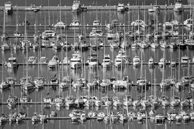 A depiction of a busy automotive assembly line in Mexico with diverse workers, highlighting the cross-border supply chain between the US and Mexico, with subtle electoral posters in the background.