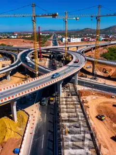 Modern highway interchange under construction in Mexico, symbolizing large-scale infrastructure investment.