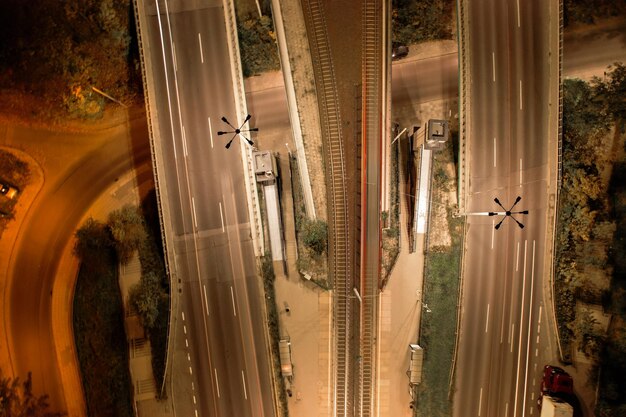 A bustling logistics hub in Mexico, with semi-trucks, trains, and warehouses under construction, symbolizing growing infrastructure and supply chain activity. Dynamic, industrial, wide shot.