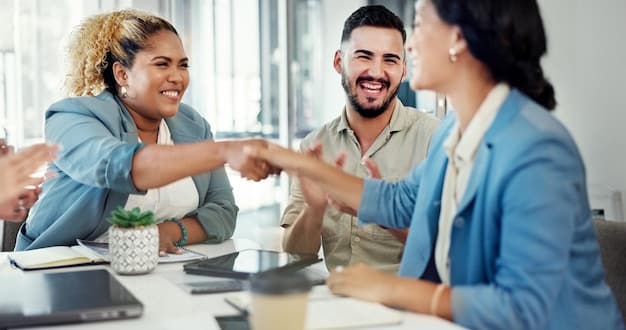 A diverse group of business professionals from US and Mexico shaking hands over a table with documents and laptops, illustrating successful cross-border collaboration and partnership. Focus on mutual benefit.