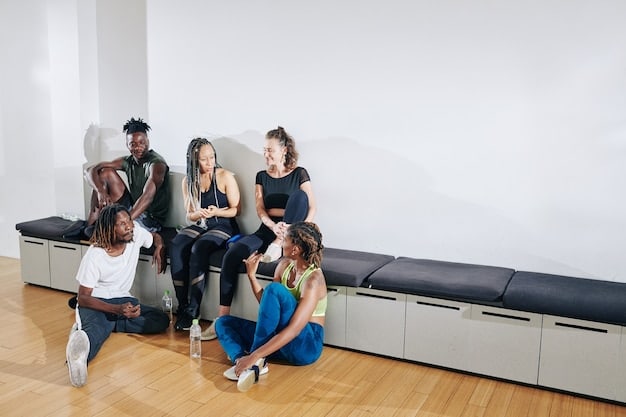 A diverse group of people, including adults and children, sitting in a waiting room of an immigration office, looking anxious with documents in their hands. The room is modern and well-lit, suggesting a formal processing environment.