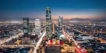 Mexico City skyline at dusk, symbolizing national security challenges and strategies.