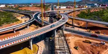 Modern highway interchange under construction in Mexico, symbolizing large-scale infrastructure investment.